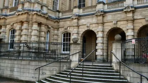 Exterior view of Reading Crown Court with steps up to arched entrance to the building