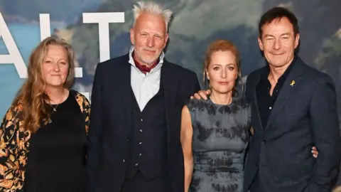 Getty Images (L-R) Raynor Winn, Moth Winn, Gillian Anderson and Jason Isaacs attend the UK Special Screening of "The Salt Path" at The Curzon Soho on May 22, 2025 in London, England. 