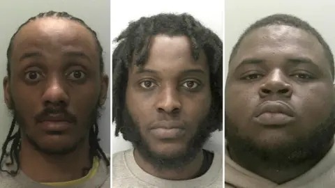 Devon and Cornwall Police Composite image of police mugshots of Ramarnee Bakas, Israel Augustus and Abdulrasheed Adedoja. All three men are black and wearing grey jumpers.