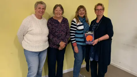 Eileen Welby Eileen (second from the left) with three other members of one of her books club. One of them on the right is holding a copy of Bob Mortimer's book 'Satsuma'