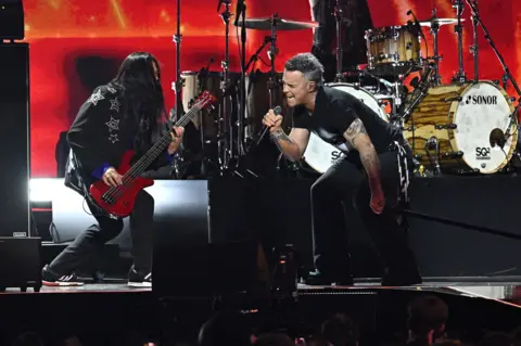 PA Media Robbie Williams on stage at the Brit Awards