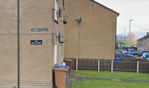 A beige building with a Linden Place sign on it