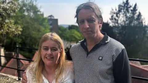 Sharon is pictured with her partner Martin