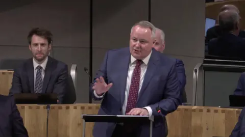 Senedd Cymru Darren Millar asking a question during First Minister's Questions on Tuesday.