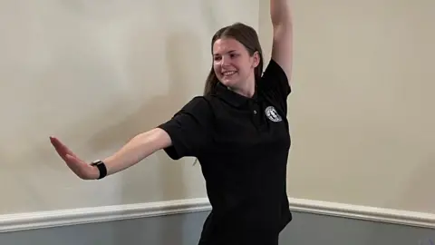 Tom MacDougall/BBC Alicia Bembridge striking a dance pose.