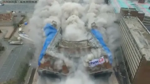 Bus station in the process of being demolished in a big explosion.