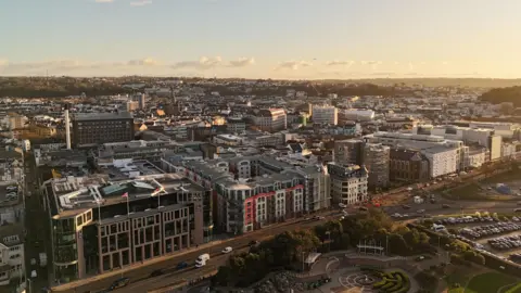 Drone shot of St Helier, Jersey showing buildings and roads in a large area. 