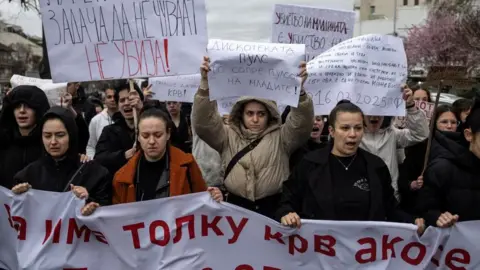 Reuters Street protesters in Kocani, mostly women, holding posters and banners, angry about the fire of the nightclub that killed 59 the weekend