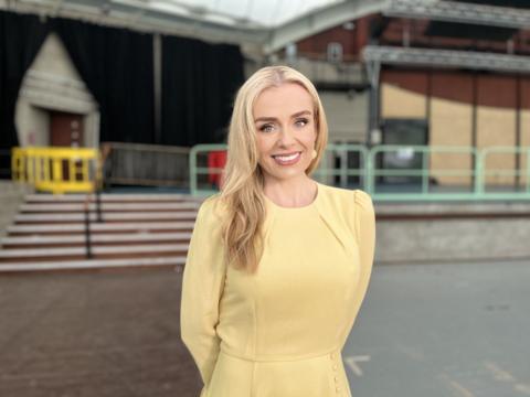 Katherine Jenkins smiling in a yellow dress