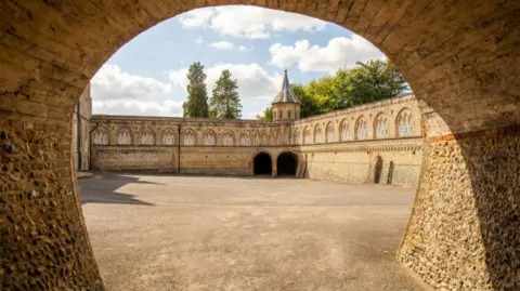 Galileo Photography An tunnel leading to a large estate. 