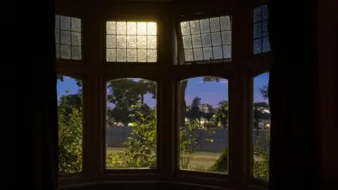 Getty Images Windows open at house