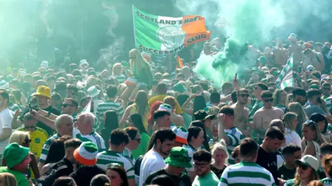 Celtic fans let off smoke bombs after gathering in the Trongate area after the club were presented with the Scottish Premiership trophy last May