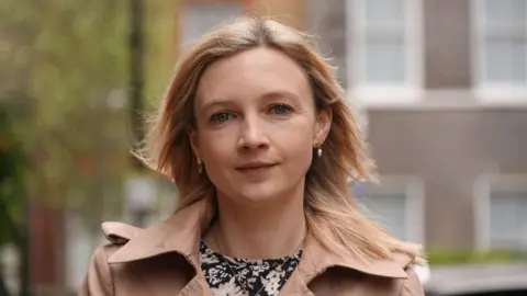 Sarah North is outside in a quiet London street looking directly at the camera