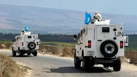 EPA-EFE/REX/Shutterstock United Nations Interim Force (UNIFIL) vehicles patrol in Wazzani village, southern Lebanon, 15 September 2024