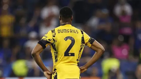 Getty Images A rear view of Denzel Dumfries in a yellow Inter Milan strip with his name on it and the number two