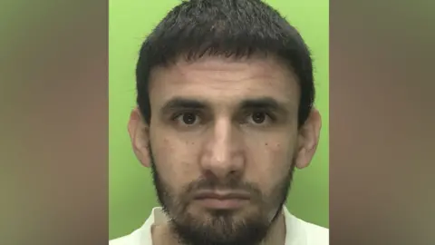 Custody photo of man with beard