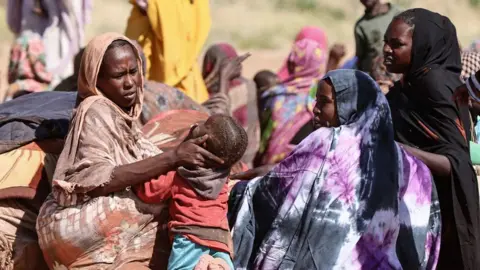 Sudanese women and children gathered in a camp near the town of Tawira in North Darfur on February 11, 2025, were evacuated