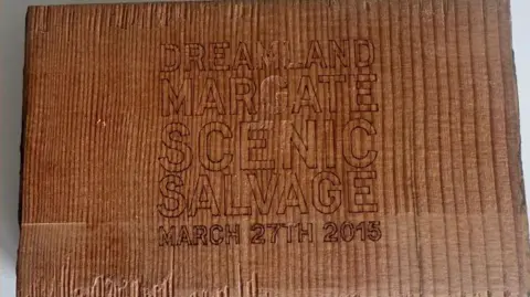 Lorraine Barnard The burnt piece of wood salvaged from the Scenic Railway in Margate, Kent. The piece of wood has 'Dreamland, Margate, Scenic Salvage - March 27th 2015' engraved into it.