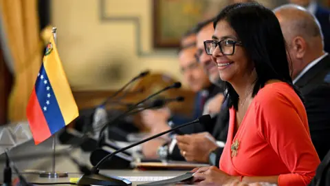 Venezuela's interim President Delcy Rodriguez smiles during a meeting at the Miraflores Presidential Palace in Caracas