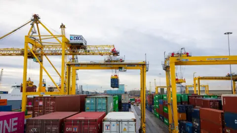 Getty Images A port with large shipping containers of various sizes and colours