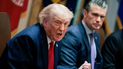 US President Donald Trump (left) speaks next to US Defence Secretary Pete Hegset during a cabinet meeting at the White House, Washington. Photo: 26 May 2026