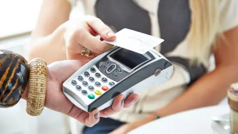 A woman paying using a card