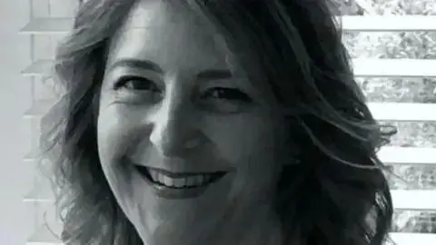 Surrey Police Close up black and white image of a smiling Samantha Mickleburgh