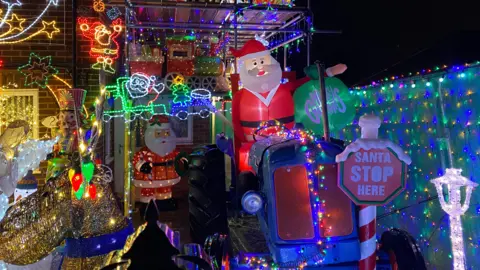 A working tractor being driven by an inflatable Santa