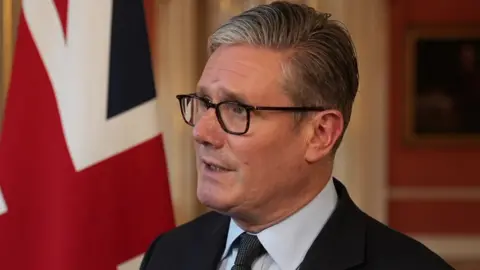 Prime Minister Sir Keir Starmer makes a statement in Downing Street behind a Union flag