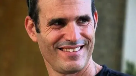 The Hostages and Missing Families Forum Dror Or, who has dark hair and is smiling