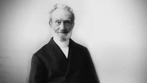 George Müller Trust Black and white image of George Müller. He is older in the image and has white hair and a white beard. He is wearing a dark coat, with a high necked white shirt underneath