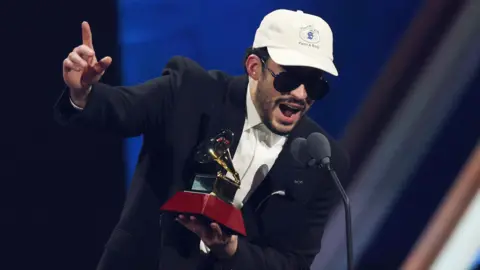 Getty Images Bad Bunny accepts his Latin Grammy award