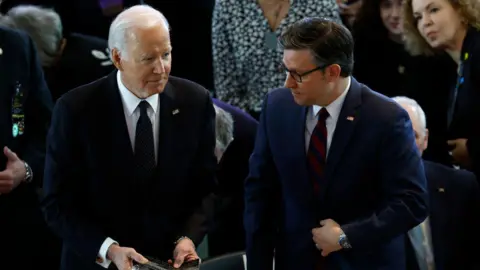 Getty Images Joe Biden with House Speaker Mike Johnson