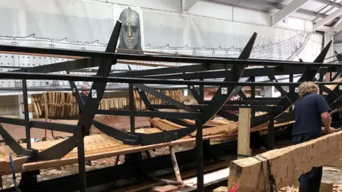Darren Rozier/BBC A replica of the Sutton Hoo ship half way through its build