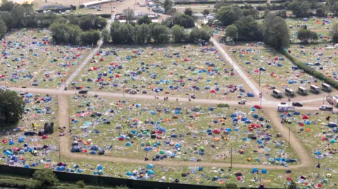 Big Ladder Photographer Aerial view, taken by a drone, of Reading Festival aftermath with scattered tents and rubbish left behind by festival-goers.