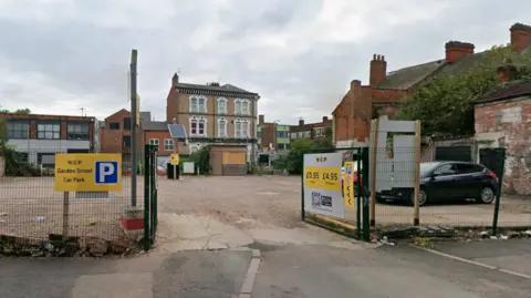 A street view of a car park with yellow NCP signage
