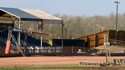 Leicester Lions Speedway Gantry partly hanging lose and more of it on the ground of speedway track.