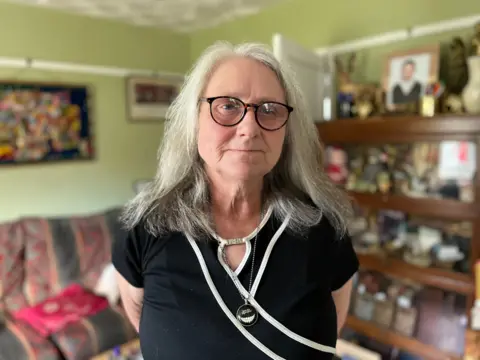 Shaun Whitmore/BBC  Pamelia Widdison standing in her living room in Watton in Norfolk