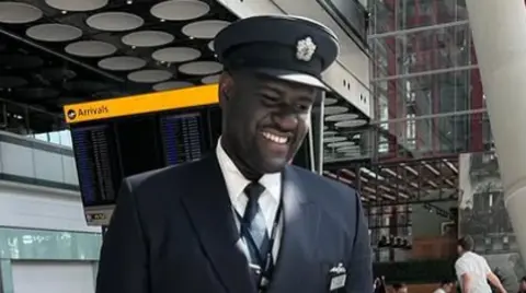 Crown Prosecution Service Yeboah in his British Airways uniform which includes a navy suit and hat. He is smiling and looking off-camera.