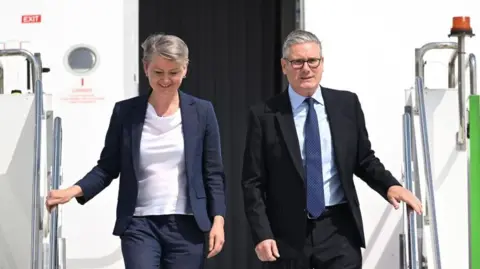 British Prime Minister Sir Keir Starmer (R) and British Foreign Secretary Yvette Cooper (L) disembark from a plane at Esenboga Airport ahead of the 2026 Nato summit in Ankara, 7 July