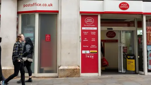 Getty Images People walking in front of a post office in London