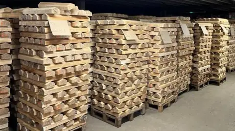 Thousands of cricket bat blades stacked on pallets and graded in the Gray Nicolls warehouse