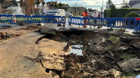 Kidmore Road collapsed with blue fence around it