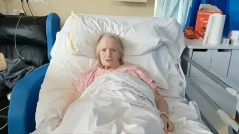 Family Jean Morgan in a hospital bed