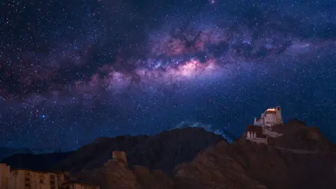 Extreme long exposure image showing milky way with Namgyal Tsemo Gompa, main buddhist monastery centre in Leh, Ladakh, India