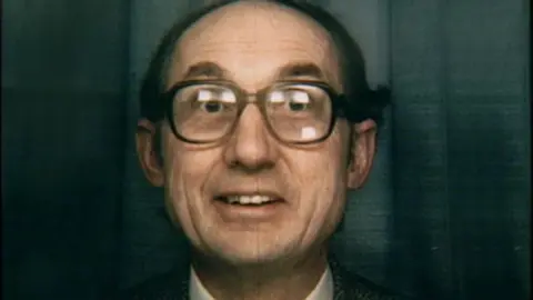 Supplied A grainy head-and-shoulders picture of Dr David Birkett. He has receding dark hair and is wearing glasses. He is smiling at the camera with a slightly surprised expression.