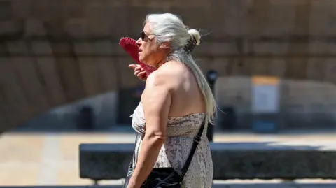 A woman fans herself during the June heatwave in Madrid