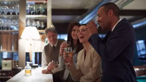 Getty Images Business people drinking in a bar