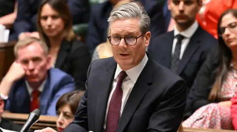 UK Parliament Keir Starmer speaks in the Commons, wearing a dark suit and burgundy tie