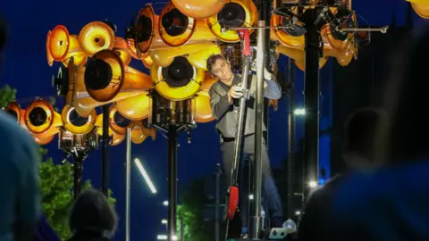 Stockton Borough Council A man plays an instrument crafted from repurposed air raid sirens.